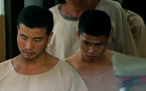 Myanmar murder defendants Zaw Lin, left, and Wai Phyo, right, are escorted by Thai police officers last month after they were sentenced to death at a provincial court in Thailand - Credit: RUNGROJ YONGRIT/EPA-EFE/REX/REX