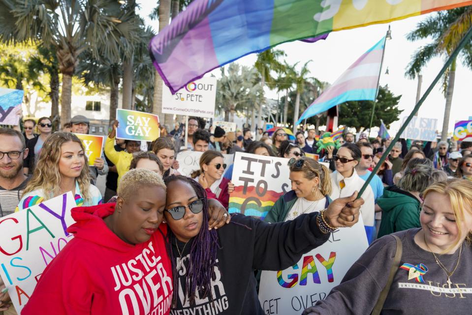 FILE - Florida House Representative Michele Rayner, left, hugs her spouse, Bianca Goolsby, during a march at city hall in St. Petersburg, Fla., on March 12, 2022, to protest the controversial "Don't Say Gay" bill passed by Florida's Republican-led legislature. While Florida has received national attention for what opponents call the "Don't Say Gay" law, the trend is national, particularly in red states. The American Civil Liberties Union is tracking nearly 470 bills it considers to be anti-LGBTQ+, most of which are in states with Republican-controlled the Legislature, such as Texas, Missouri, Florida and Tennessee.(Martha Asencio-Rhine/Tampa Bay Times via AP, File)
