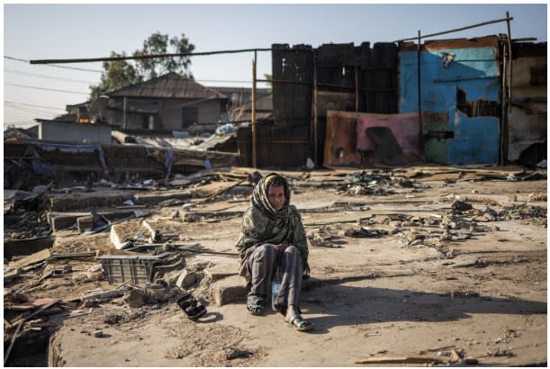 <span>A woman sits on the ground among debris from demolished structures in the historical Piazza neighbourhood of Addis Ababa on March 17, 2024 (MICHELE SPATARI / AFP)</span>