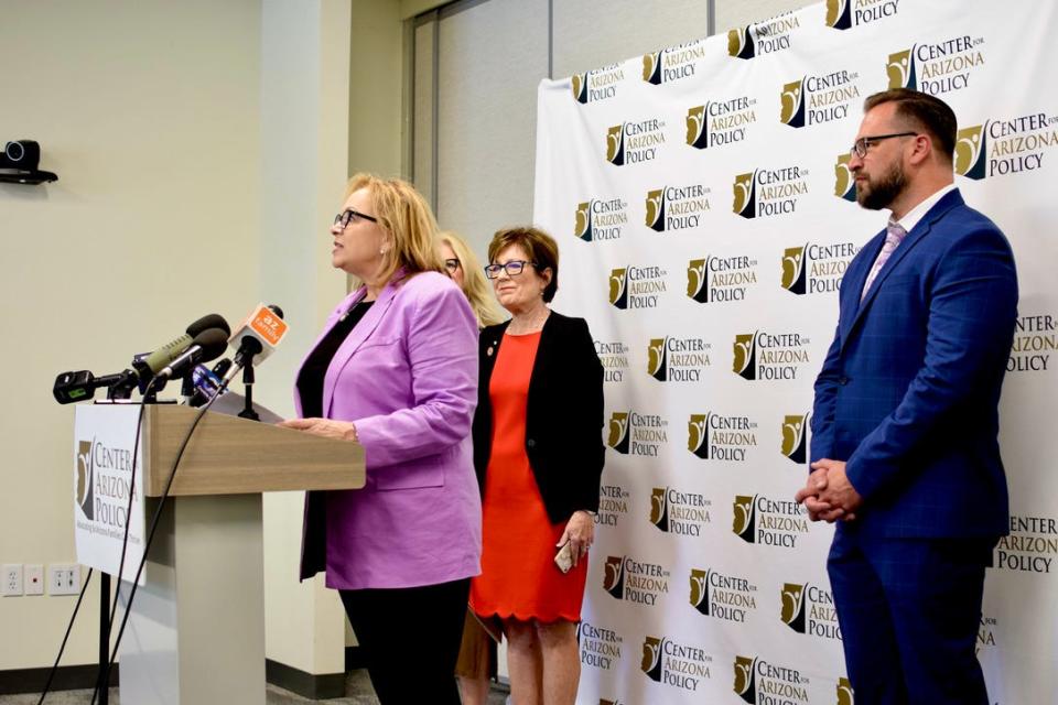 Cathi Herrod from the Center for Arizona Policy speaks at a news conference in Phoenix on the overturning of Roe v. Wade on June 24, 2022. State Sen. Nancy Barto (left) and Josh Chumley (right), chief advancement officer at Choices Pregnancy Centers, watch.