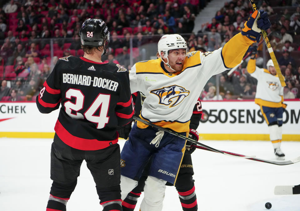 Nashville Predators center Yakov Trenin (13) celebrates his goal in front of Ottawa Senators defenseman Jacob Bernard-Docker (24) during the first period of an NHL hockey game in Ottawa, Ontario, Monday, Jan. 29, 2024. (Sean Kilpatrick/The Canadian Press via AP)