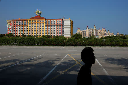 A man walks in front of Chimelong Hengqin Bay Hotel (R) and Chimelong Circus Hotel at Hengqin Island adjacent to Macau, China September 13, 2017. REUTERS/Bobby Yip