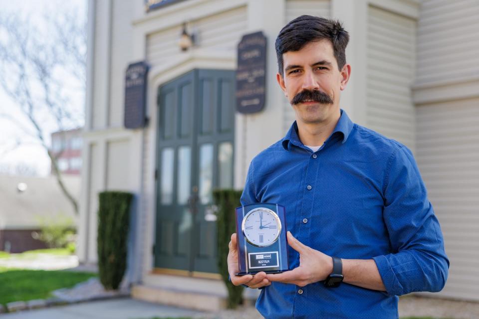 Drew Furtado, director of the short film 'Sharing,' holds the award for Best Film that was shot at the Seamen's Bethel in March.