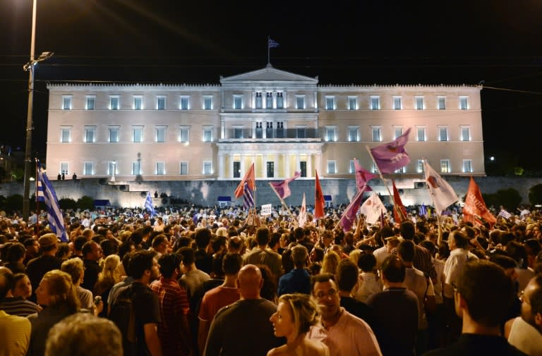 People celebrate in Athens on July 5, 2015 after the first exit-polls of the Greek referendum