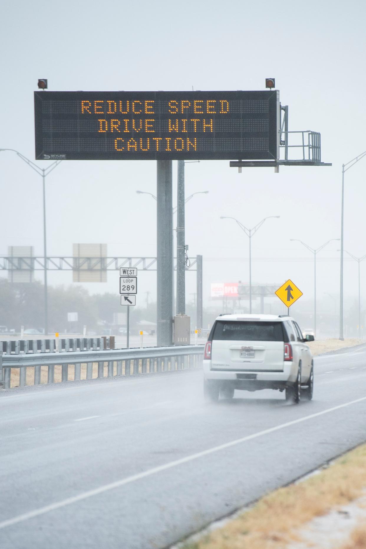 A TxDOT dynamic message board on South Loop 289 cautions drivers ahead of expected wintry weather.