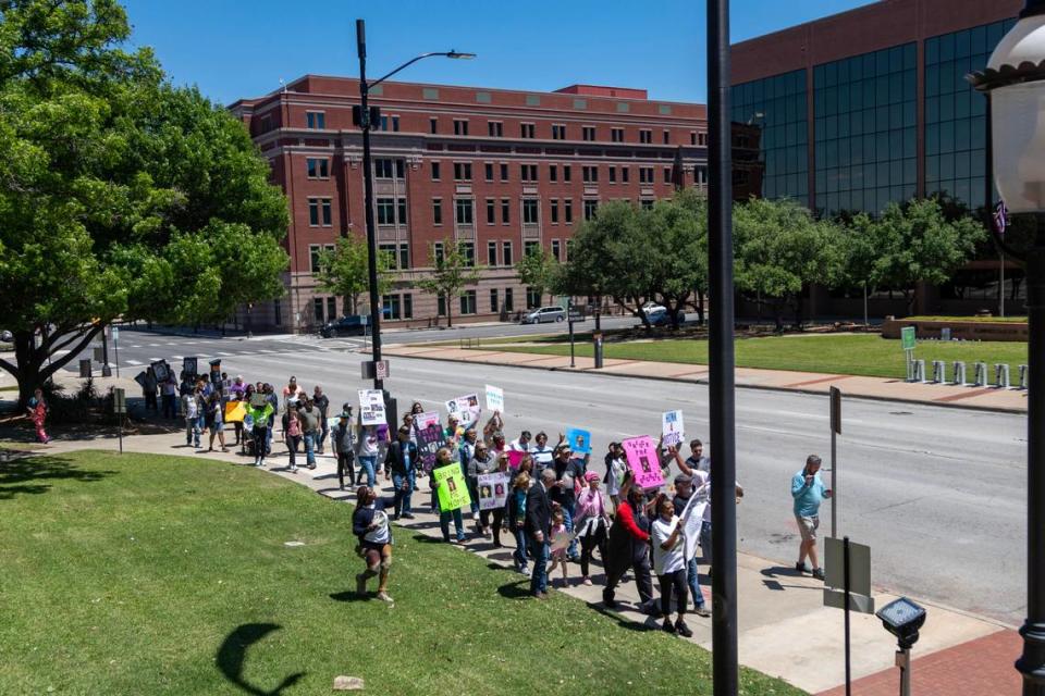 Dozens of people impacted by cold cases gather at the Tarrant County Courthouse in Fort Worth on Saturday, April 29, 2023. They walked downtown to urge local authorities to “thaw the cold cases” and settle unsolved murders, disappearances and crimes.