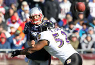 FOXBORO, MA - JANUARY 10: Tom Brady #12 of the New England Patriots is hit as he throws the ball by Ray Lewis #52 of the Baltimore Ravens during the 2010 AFC wild-card playoff game at Gillette Stadium on January 10, 2010 in Foxboro, Massachusetts. (Photo by Jim Rogash/Getty Images)