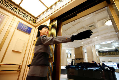 22-year-old elevator operator Yuria Nagamoto works at Takashimaya department store in Tokyo, Japan October 18, 2018. Picture taken October 18, 2018. REUTERS/Issei Kato