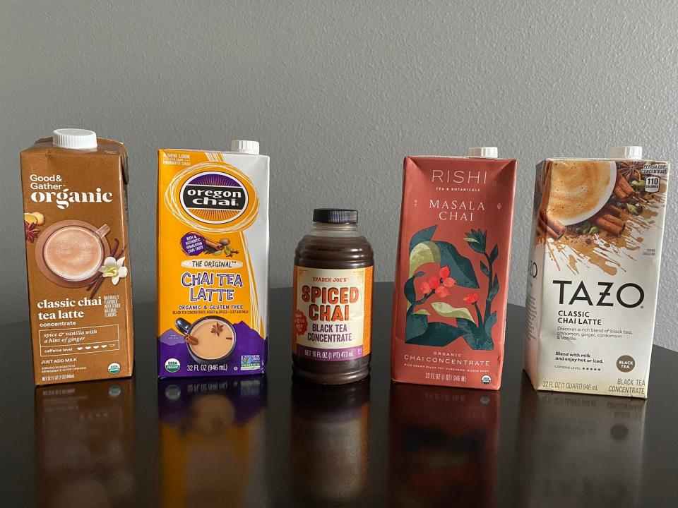 Containers of chai tea concentrate lined up next to each other from Good & Gather, Oregon Chai, Trader Joe's, Rishi, and Tazo.