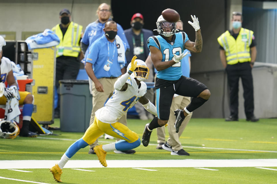 Carolina Panthers wide receiver D.J. Moore (12) makes a catch in front of Los Angeles Chargers cornerback Michael Davis during the second half of an NFL football game Sunday, Sept. 27, 2020, in Inglewood, Calif. (AP Photo/Alex Gallardo)