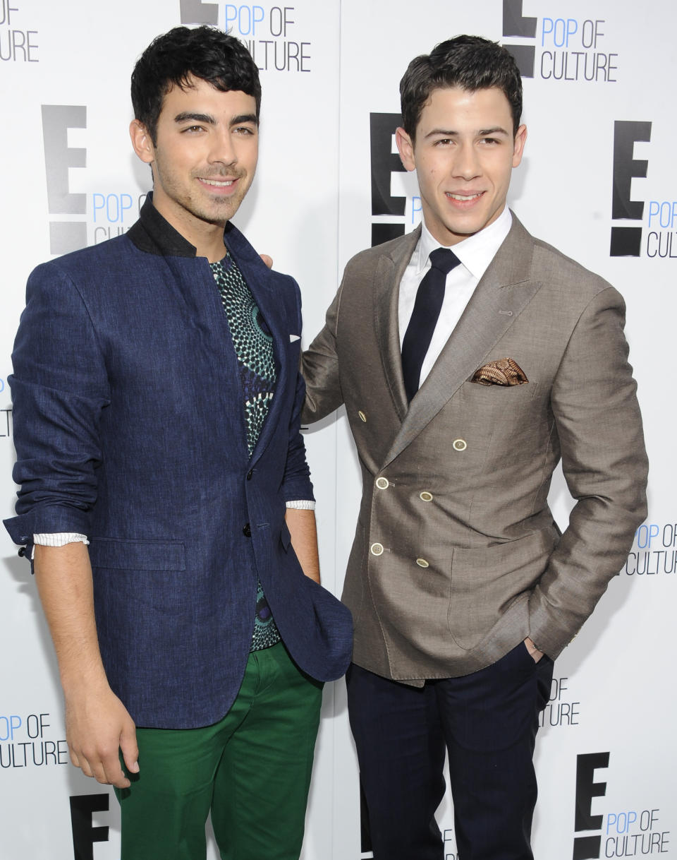 Joe Jonas, left, and Nick Jonas from the show "Married To Jonas" attend an E! Network upfront event at Gotham Hall on Monday, April 30, 2012 in New York. (AP Photo/Evan Agostini)