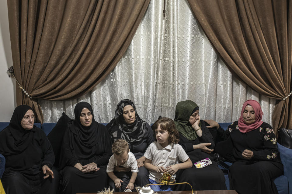 Relatives of Jameel Nijim, who was killed during an Israeli raid, sit at home in Jabalia, northern Gaza Strip, Tuesday, Aug. 16, 2022. A Palestinian human rights group and an Israeli newspaper reported Tuesday that an explosion in a cemetery that killed five Palestinian children during the latest flare-up in Gaza was caused by an Israeli airstrike and not an errant Palestinian rocket. (AP Photo/Fatima Shbair)