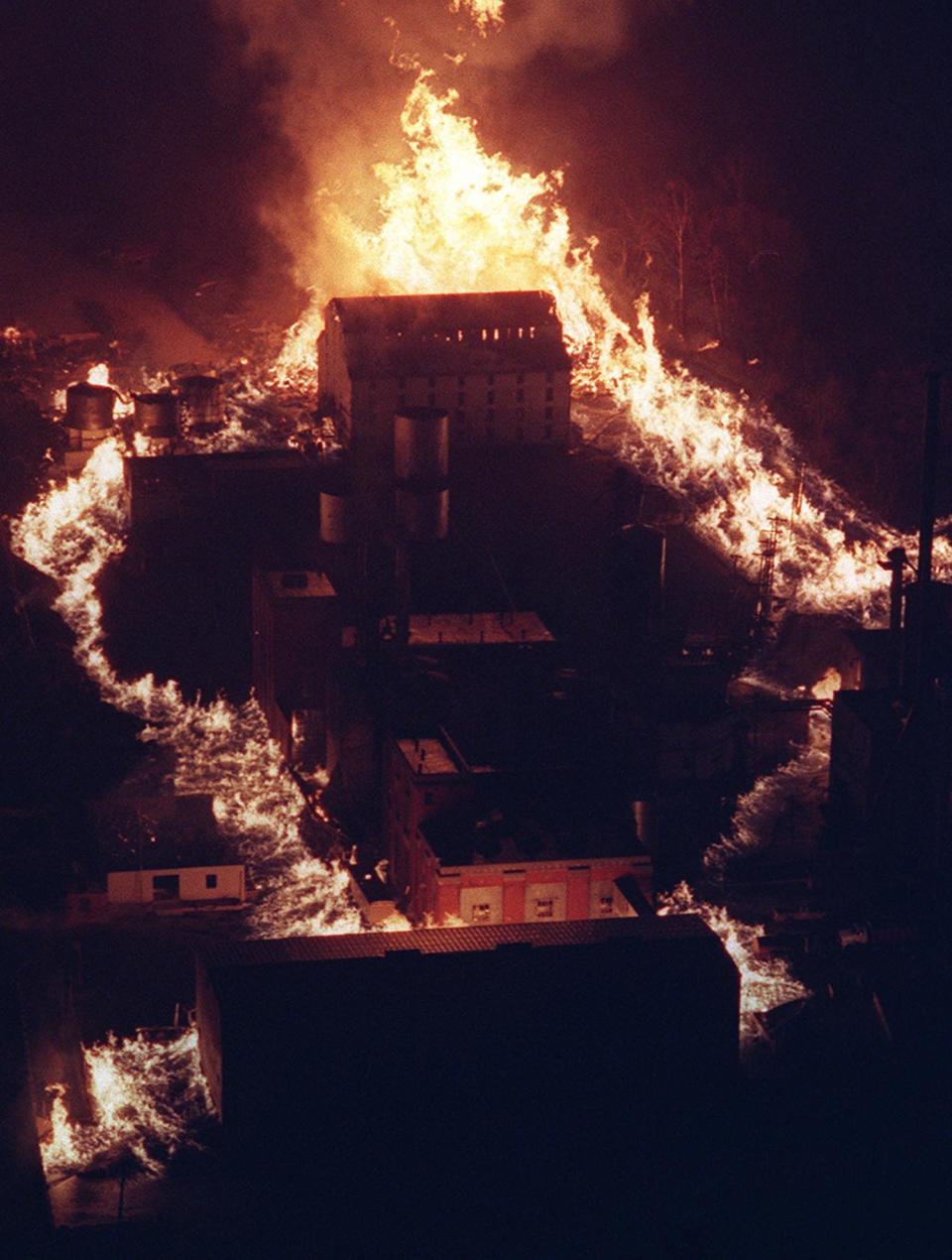 Flames rise at Heaven Hill Distilleries in Bardstown in 1996. Witnesses said heat from the fire could be felt a half mile away. 
 James Wallace/Courier Journal
Flames licking around buildings at Heaven Hill Distilleries in Bardstown lit up the skies as darkness began to fall. Burning bourbon flowed from warehouses, and witnesses said heat from the fire could be felt a half mile away.
Nov. 7, 1996.