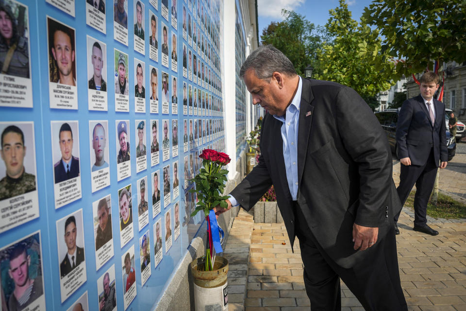 Republican presidential candidate former New Jersey Gov. Chris Christie lays flowers at the Wall of Remembrance to pay tribute to killed Ukrainian soldiers in Kyiv on Aug. 4, 2023. (Efrem Lukatsky / AP)