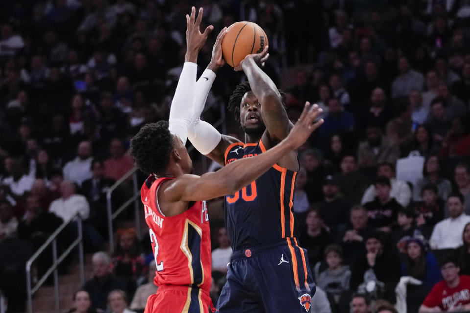 New York Knicks forward Julius Randle, right, shoots a 3-point basket past New Orleans Pelicans guard Josh Richardson (2) during the first half of an NBA basketball game, Saturday, Feb. 25, 2023, at Madison Square Garden in New York. (AP Photo/Mary Altaffer)