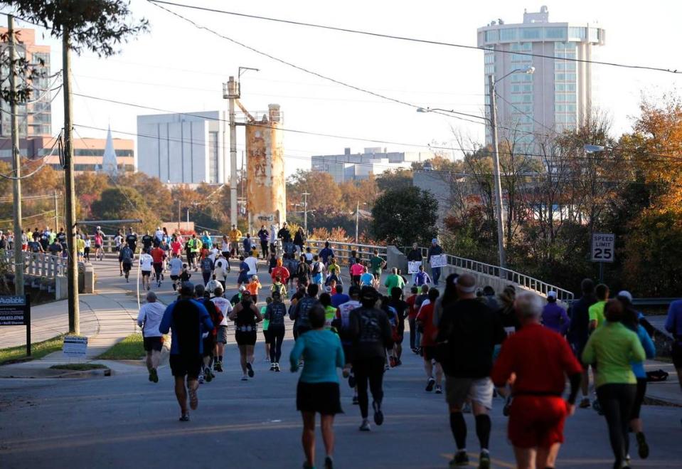 Runners cross the Boylan Avenue bridge during the Raleigh City of Oaks Marathon and Rex Healthcare Half Marathon Sunday, November 3, 2013.