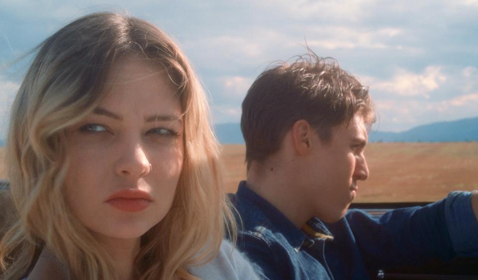 closeup of Daveigh sitting in the passenger seat of a car