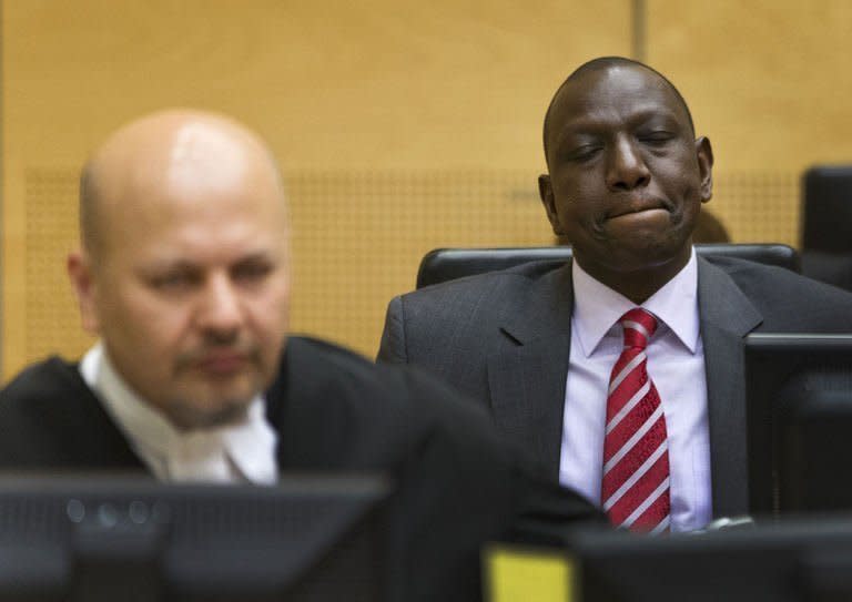 Kenya's Vice President William Ruto (R) sits in the courtroom before the start of his trial at the International Criminal Court (ICC) in The Hague on September 10, 2013