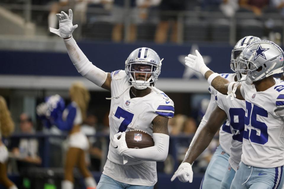 Dallas Cowboys cornerback Trevon Diggs (7), Nahshon Wright (25) and others celebrate Diggs intercepting a Carolina Panthers' Sam Darnold pass in the second half of an NFL football game in Arlington, Texas, Sunday, Oct. 3, 2021. (AP Photo/Ron Jenkins)