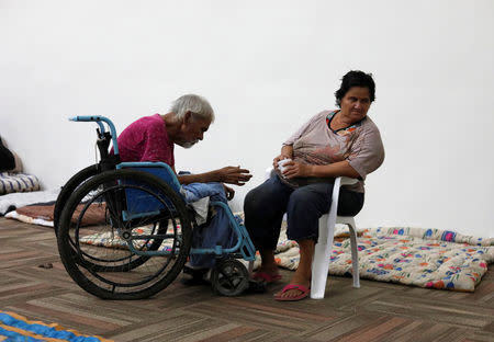 People who were evacuated from their homes are seen in a big room at the Convention Center being used as a shelter while Hurricane Willa approaches the Pacific beach resort, Mexico October 23, 2018. REUTERS/Henry Romero