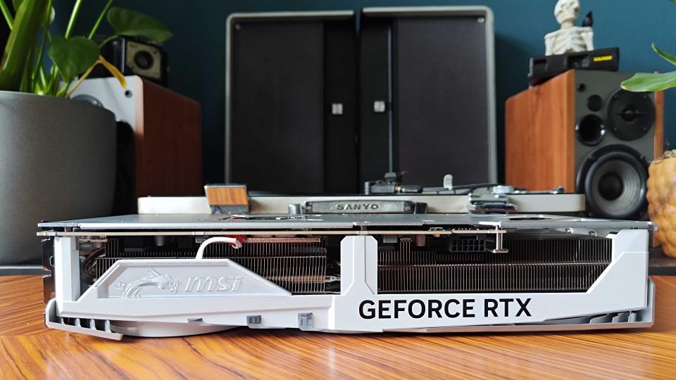 White RTX 4080 Super with power connector facing forward on woodgrain table