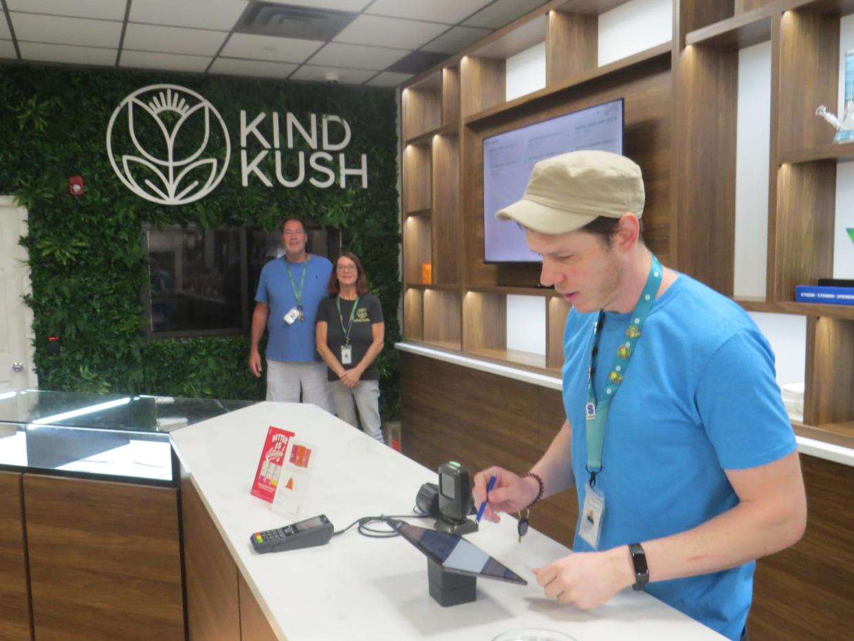 Kind Kush opened in Rockaway on August 19. Owner Jimmy Rogovich, back left, and "budtender" Debbie Mereau observe as store manager Bill Weber rings up a sale. Morris County's first legal retail cannabis dispensary officially opened in the borough on August 19.