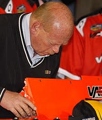 John Darby, NASCAR's director of competition in the Sprint Cup Series, inspects a rear spoiler