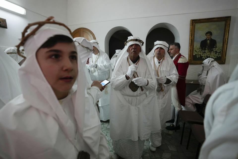 Members of a confraternity wait for the start of a Holy Thursday procession the in Procida island, Italy, Thursday, March 28, 2024. Italy is known for the religious processions that take over towns big and small when Catholic feast days are celebrated throughout the year. But even in a country where public displays of popular piety are a centuries-old tradition, Procida's Holy Week commemorations stand out. (AP Photo/Alessandra Tarantino)