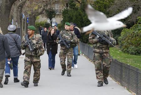 French military patrol near the Eiffel Tower the day after a series of deadly attacks in Paris , November 14, 2015. REUTERS/Yves Herman