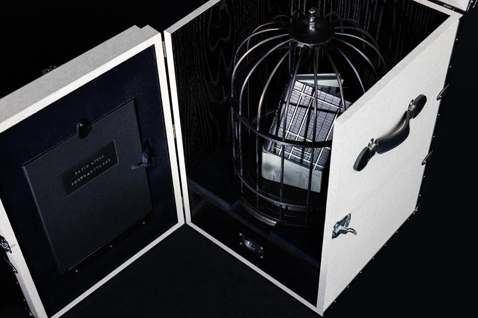Elaborate packaging for the book includes a birdcage and custom trunk.