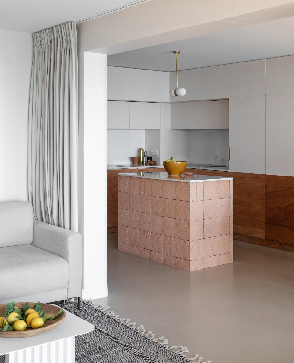 a modern kitchen with a unique tiled island