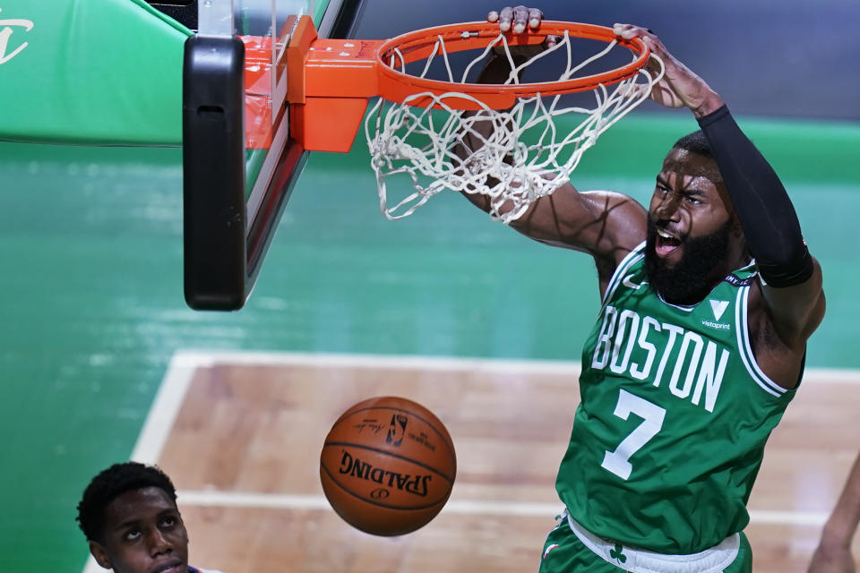 Boston Celtics guard Jaylen Brown (7) dunks against New York Knicks guard RJ Barrett, left, during the first half of an NBA basketball game Wednesday, April 7, 2021, in Boston. (AP Photo/Charles Krupa)