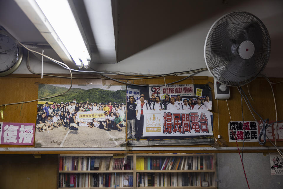 Old photos showing protests in support of Hong Kong's pro-democracy Citizens' Radio station are hung at the radio's office in Hong Kong, Friday, June 30, 2023. (AP Photo/Louise Delmotte)