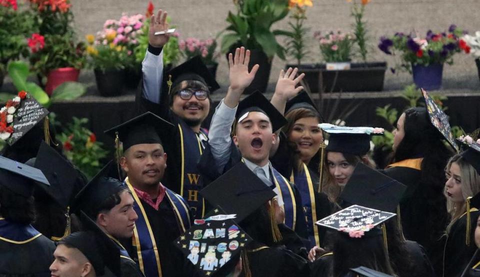 West Hills College Lemoore graduates wave at the audience during the May 25, 2023 graduation at Golden Eagle Arena.