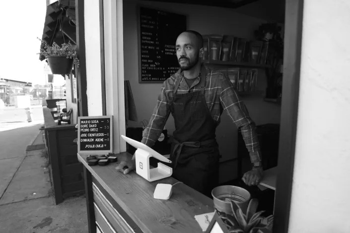 Jeff Rambo stands in his coffee shop, Storymakers Coffee Roasters.