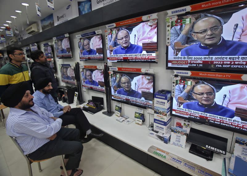 People watch television sets displaying Finance Minister Arun Jaitley presenting the budget in parliament, at an electronic shop in Chandigarh February 28, 2015. REUTERS/Ajay Verma