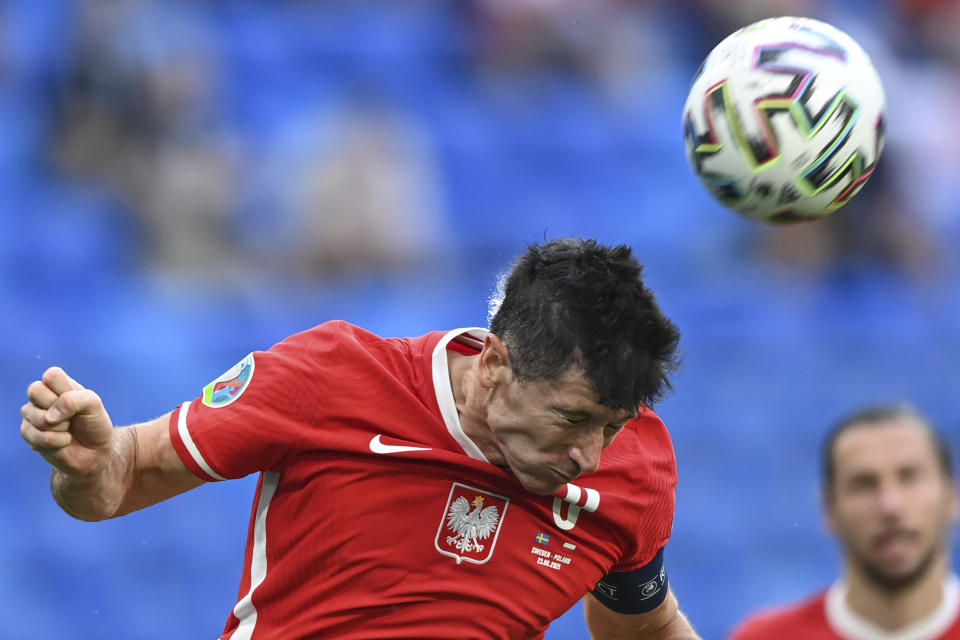 Poland's Robert Lewandowski heads the ball during the Euro 2020 soccer championship group D match between Sweden and Poland, at the St. Petersburg stadium in St. Petersburg, Russia, Wednesday, June 23, 2021. (AP Photo/Kirill Kudryavtsev, Pool)