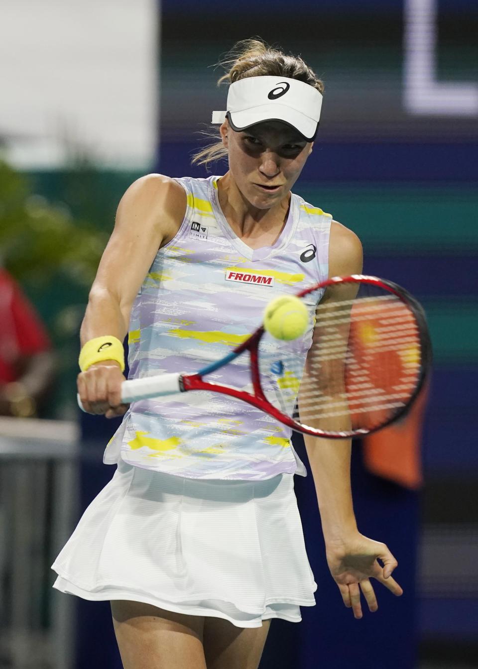 Viktorija Golubic, of Switzerland, returns the ball to Iga Swiatek, of Poland, during the Miami Open tennis tournament, Friday, March 25, 2022, in Miami Gardens, Fla. (AP Photo/Marta Lavandier)