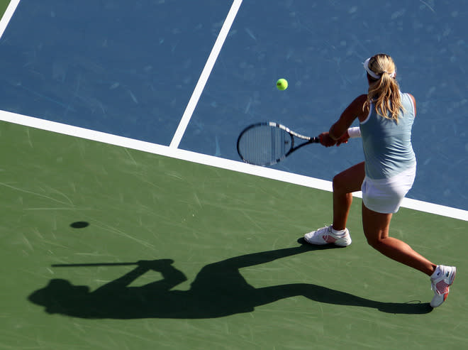 Aleksandra Wozniak of Canada returns the ball to Agnieszka Radwanska of Poland during their Dubai WTA Open tennis match in the Gulf emirate on February 21, 2012. (Photo by Karim Sahib/AFP/Getty Images)