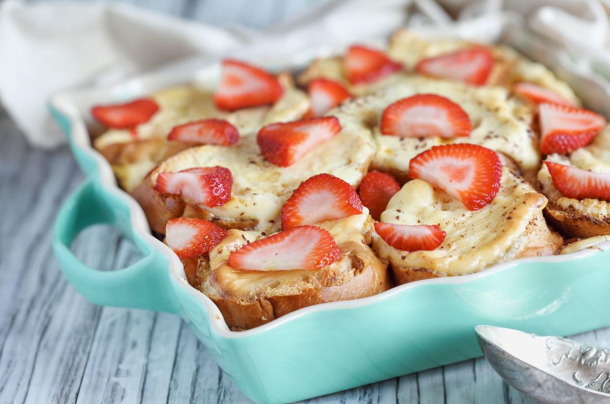 Strawberry cheesecake French toast casserole. Made with cream cheese and strawberries. Selective focus with blurred background.
