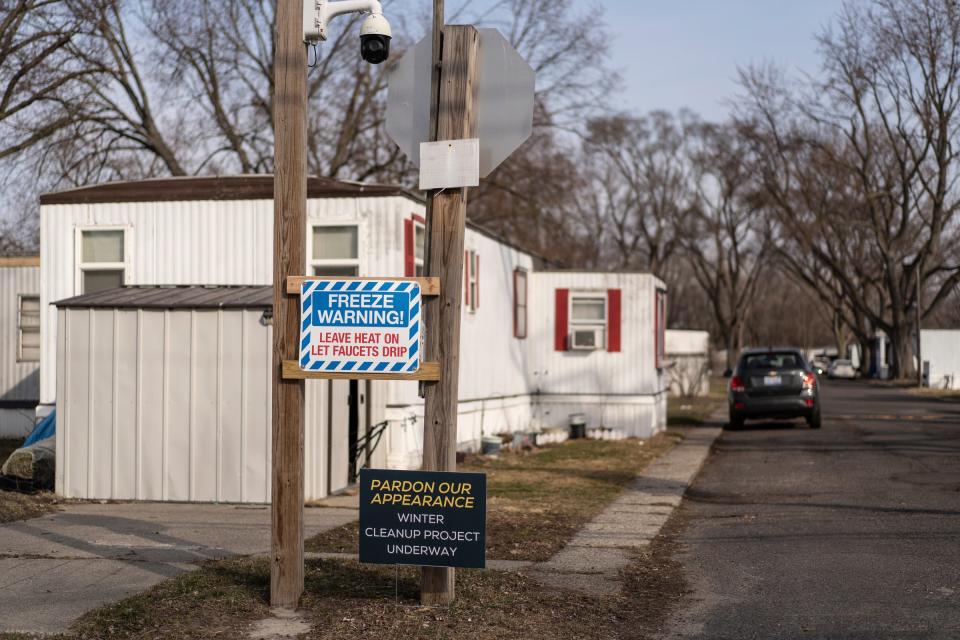 Signs are posted and a video camera hangs at an intersection in Landmark Estates mobile home park in Warren on Monday, Feb. 26, 2024.