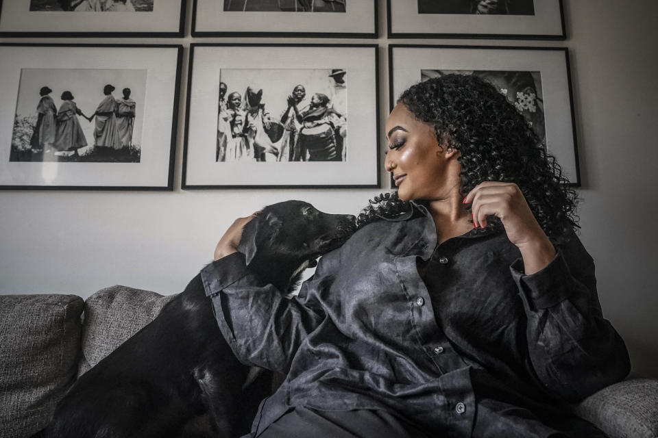 Rahwa Berhe, 30, who considers herself a crypto patron rather than an investor, plays with her rescued puppy Essie, Friday Jan. 27, 2023, in New York. (AP Photo/Bebeto Matthews)