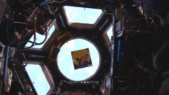 "The Wizard Who Saved the World" (Big Kid Science, 2011) by Jeffrey Bennett floating above Earth in the International Space Station's Cupola.