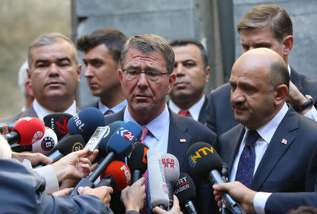 U.S. Defense Secretary Ash Carter, accompanied by Turkey's Defense Minister Fikri Isik (R), talks to media as he visits Turkish Parliament which was partly damaged during the July 15 coup attempt, in Ankara, Turkey, October 21, 2016. REUTERS/Adem Altan/Pool