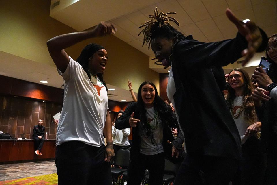 Texas players Aaliyah Moore, left, and DeYona Gaston, right, react to Sunday's announcement that the Longhorns are a No. 1 seed for the NCAA Tournament. That hasn't happened since 2004. "We know the work we've put in," Moore said.