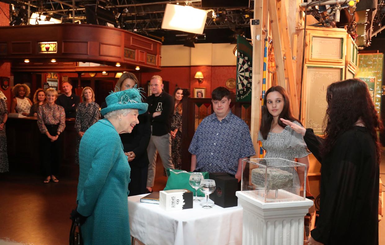 Britain's Queen Elizabeth II meets actors and members of the production team as she visits the set of the long running television series Coronation Street in Manchester, northwest England on July 8, 2021. (Photo by Scott Heppell / POOL / AFP) (Photo by SCOTT HEPPELL/POOL/AFP via Getty Images)