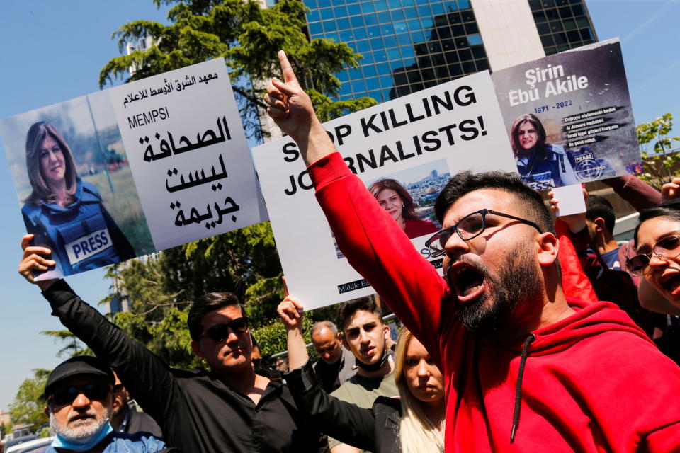 Pro-Palestinian demonstrators shout slogans as they hold placards with pictures of Abu Akleh outside the Israeli Consulate in Istanbul.