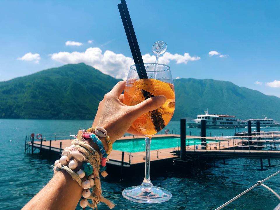 Drinking Aperol Spritz on the floating beach at Grand Hotel Tremezzo.