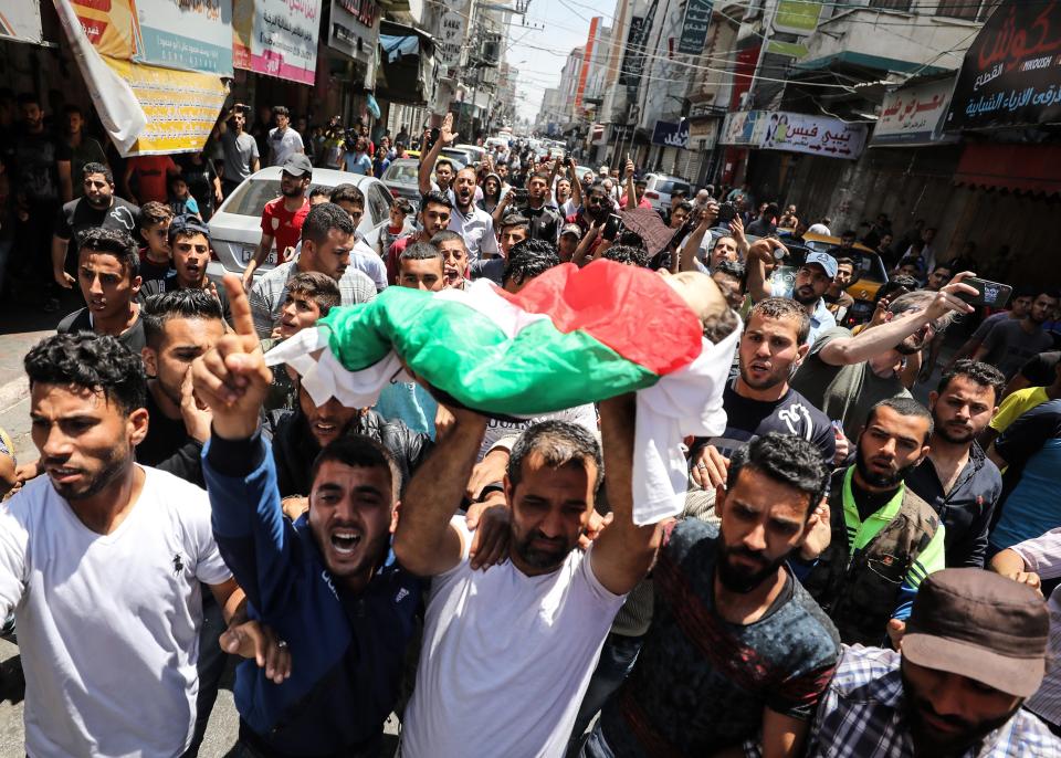 <p>Palestinian mourners carry the body of eight-month-old Palestinian baby Leila Anwar Ghandoour, died from tear gas inhalation during clashes in Gaza the previous day, during her funeral in Gaza City on May 15, 2018. (Photo: Mustafa Hassona/Anadolu Agency/Getty Images) </p>