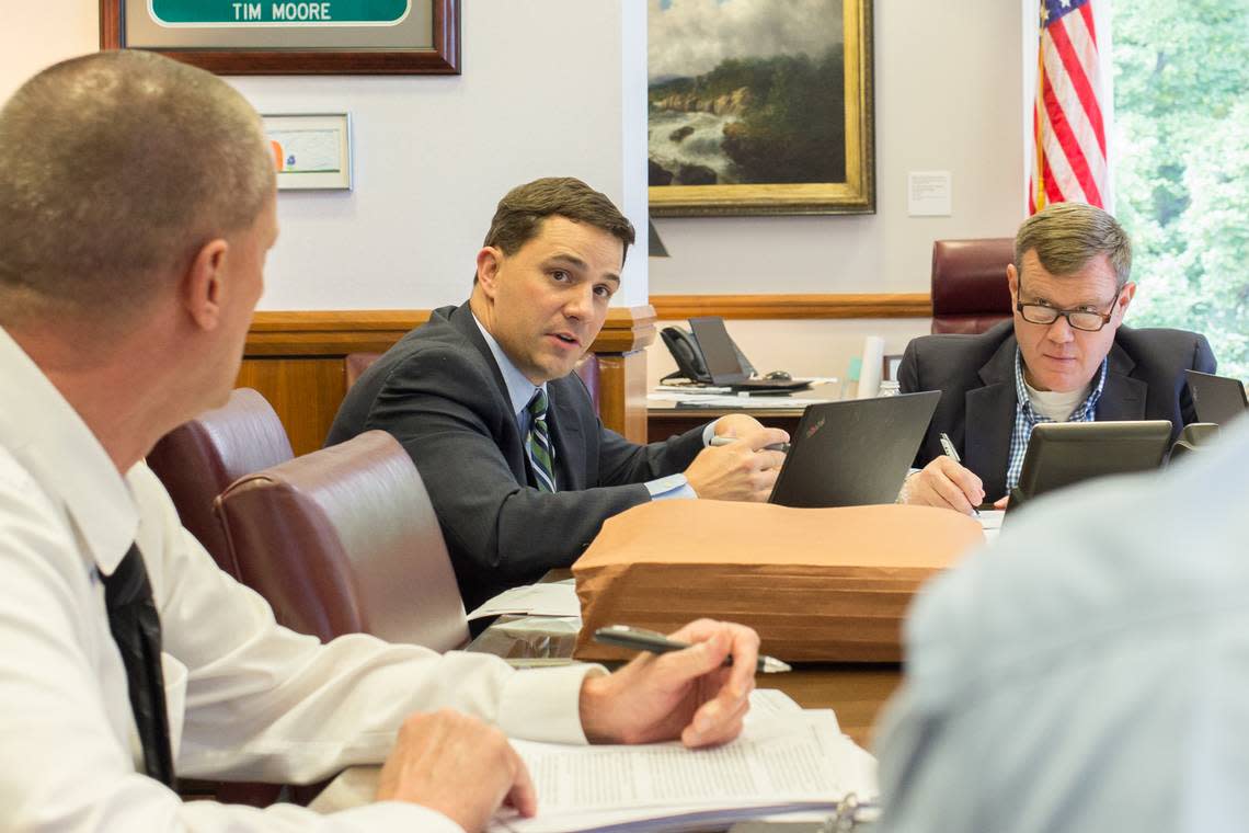 Jim Blaine, center, Senate leader Phil Berger’s chief of staff, discusses budget priorities with House Speaker Tim Moore and staffers of the North Carolina General Assembly on Friday, May 25, 2018.